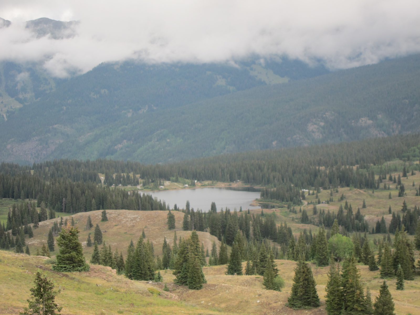 An alpine lake, Molas Lake, surrounded by high peaks - take our road for it.